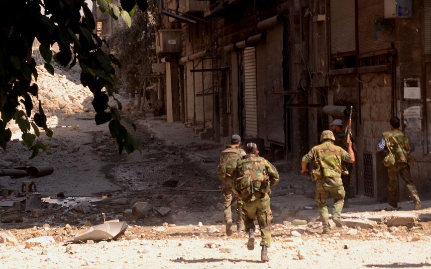 A handout picture released by the Syrian...A handout picture released by the Syrian Arab News Agency (SANA) on September 24, 2012 shows Syrian government forces running along a street strewn with debris in the northern city of Aleppo during fighting against rebel forces. According to the Syrian Observatory for Human Rights, at least 29,000 people have been killed since the revolt against Assad's rule erupted in March last year. The United Nations puts the toll at more than 20,000.   AFP PHOTO/HO/SANA 
== RESTRICTED TO EDITORIAL USE - MANDATORY CREDIT "AFP PHOTO / HO / SANA" - NO MARKETING NO ADVERTISING CAMPAIGNS - DISTRIBUTED AS A SERVICE TO CLIENTS ==-/AFP/GettyImages