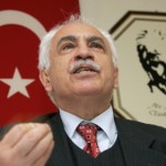 Turkish Workers Party (IP) leader Dogu Perincek gestures in fron