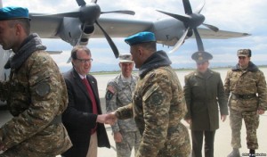 U.S. Ambassador Richard Mills shakes hands of Armenian soldiers boarding a U.S. military transport plane in Yerevan